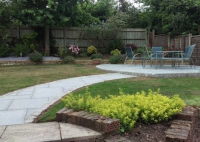 A photo of a patio garden after landscaping construction with outdoor furniture