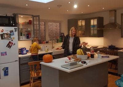 Photo of a client (a mother and son) in their newly built kitchen