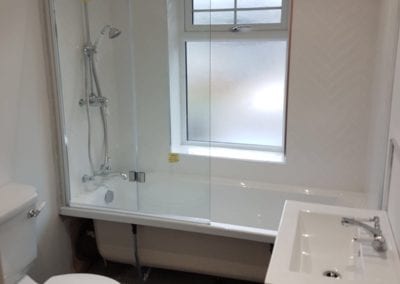 Photo of a bathroom, with a toilet and bathtub