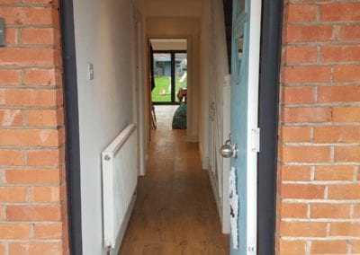 Photo of the front door opened, looking through the entire house