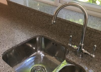 Photo of a shiny new kitchen sink and tap