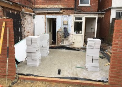 Photo of a construction area with white bricks piled up