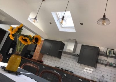 Photo of a newly built kitchen, focusing on hanging light fittings