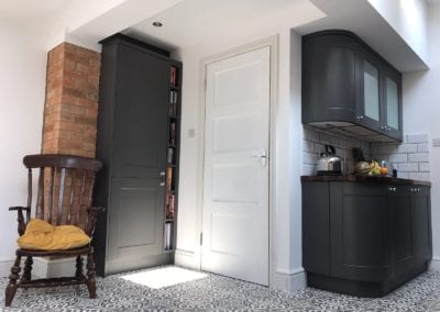 Partial image of a kitchen with a kettle and fruit on the worktops