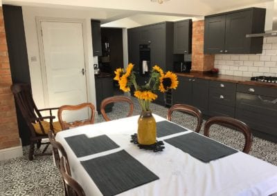 Photo of a kitchen and dining room, with Sunflowers on the table