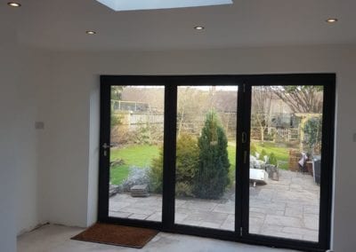 Photo of a backroom with the garden view through a wide patio door