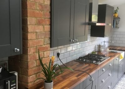 Dark grey kitchen with wood laminate worktop