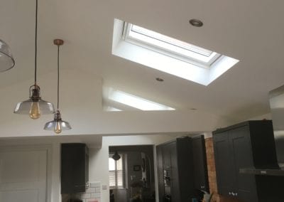 Dark grey kitchen with wall hung lights and sky lights