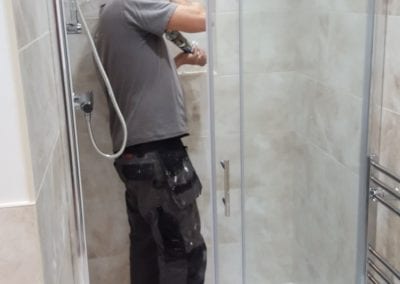 Fitter working on a recess pocket in the shower